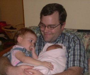 Zachary holding two of his daughters